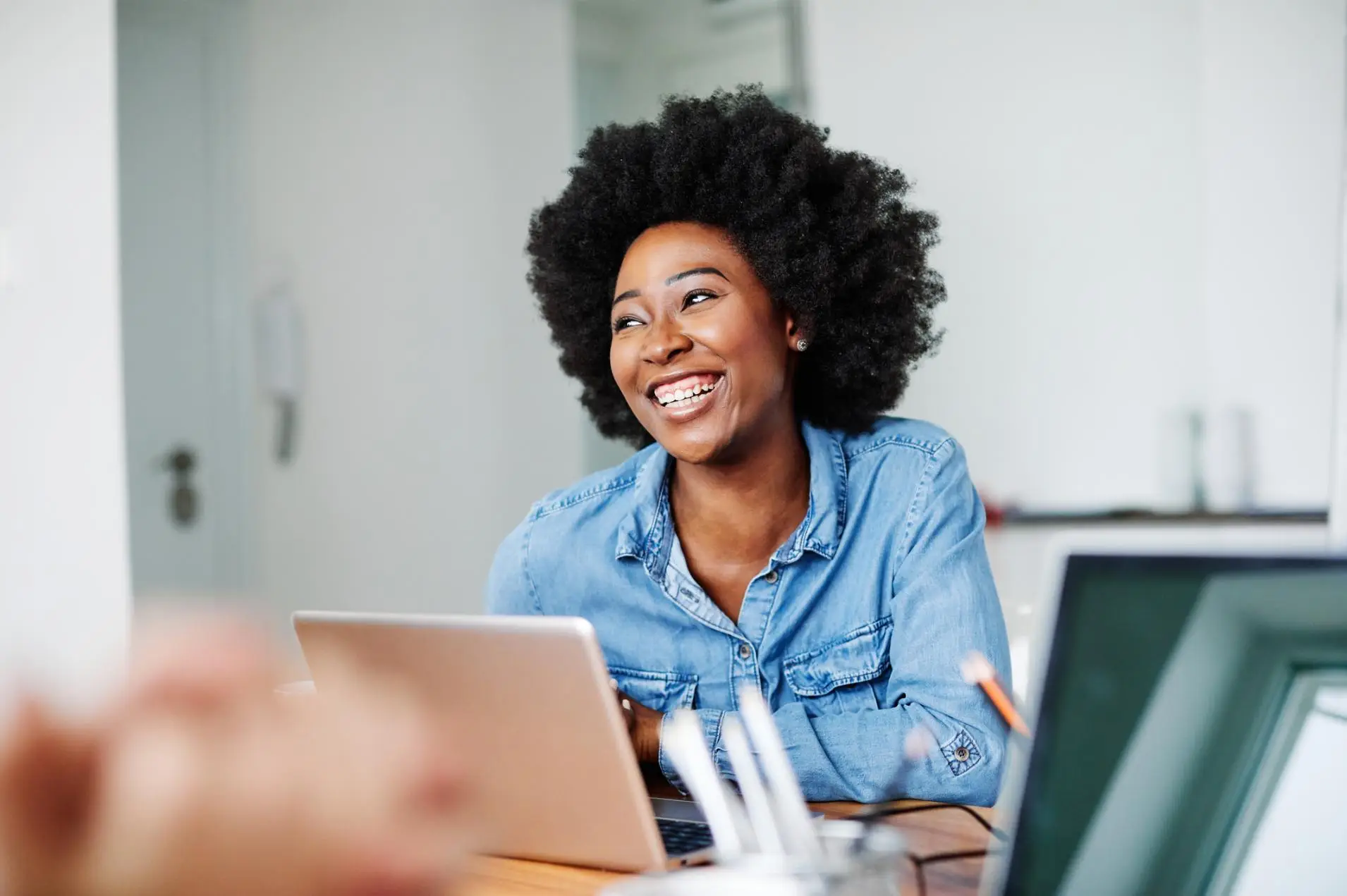 Attractive african american business woman in a modern office or a student in a classroom