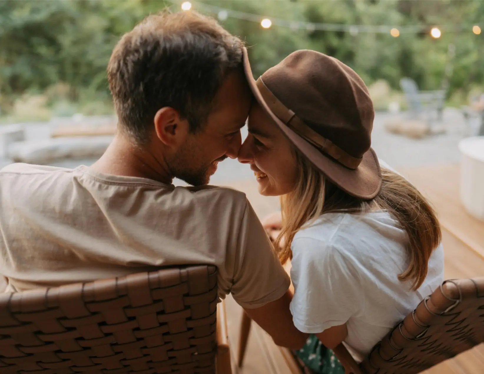 Photo of a loving couple, spending quality time together at the end of the busy week in front of their vacation home, overlooking river